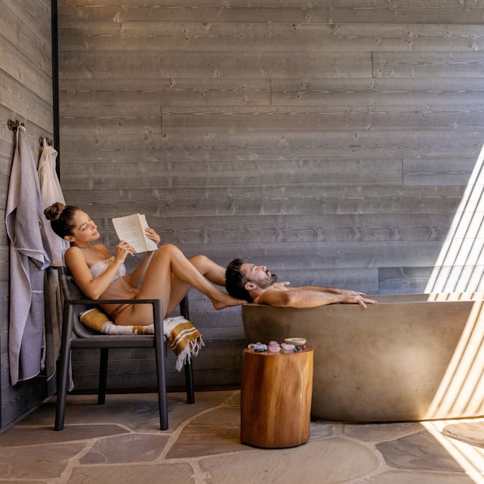Man in a Bathtub and a Woman Reading and Relaxing at the Spa