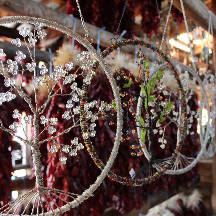 Hanging dreamcatchers with small gemstones attached to them