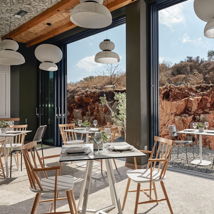 The Griglia modern indoor dining area next to large windows looking onto outdoor dining area.