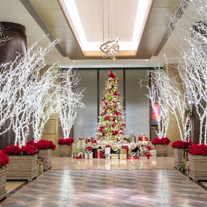 Hotel Lobby Decorated with a Tree, Poinsettias and Fancy Lights to Celebrate the Holidays