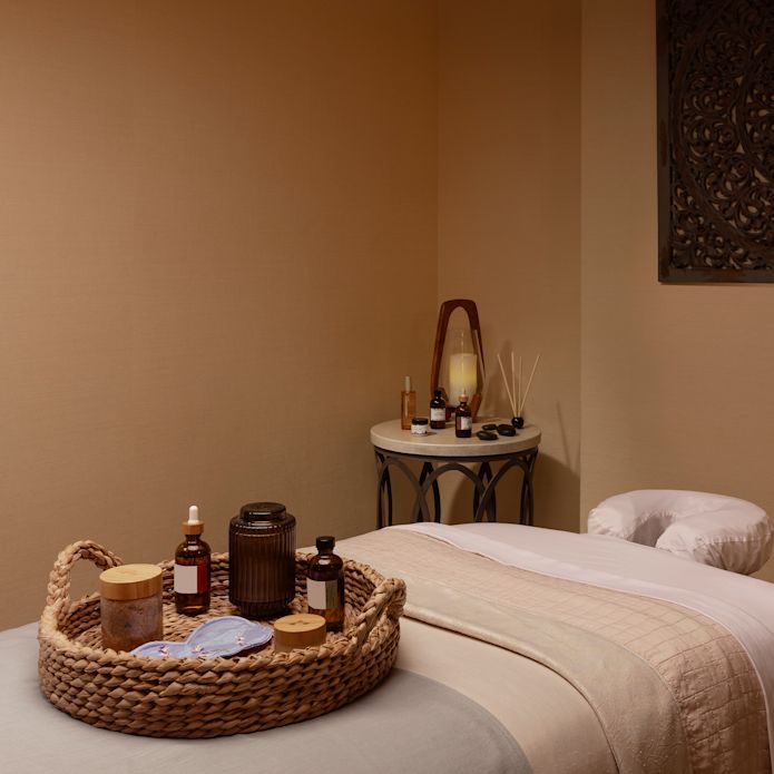 spa treatment room, basket of spa products  and a mask