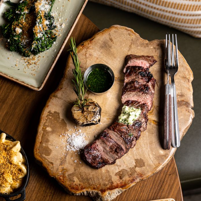 a Dish with Meat Sauce Asparagus and Broccoli on a Table at Galley Restaurant