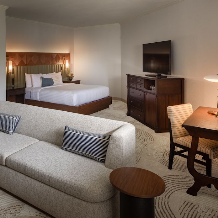 Guest room with bed, sofa, and TV