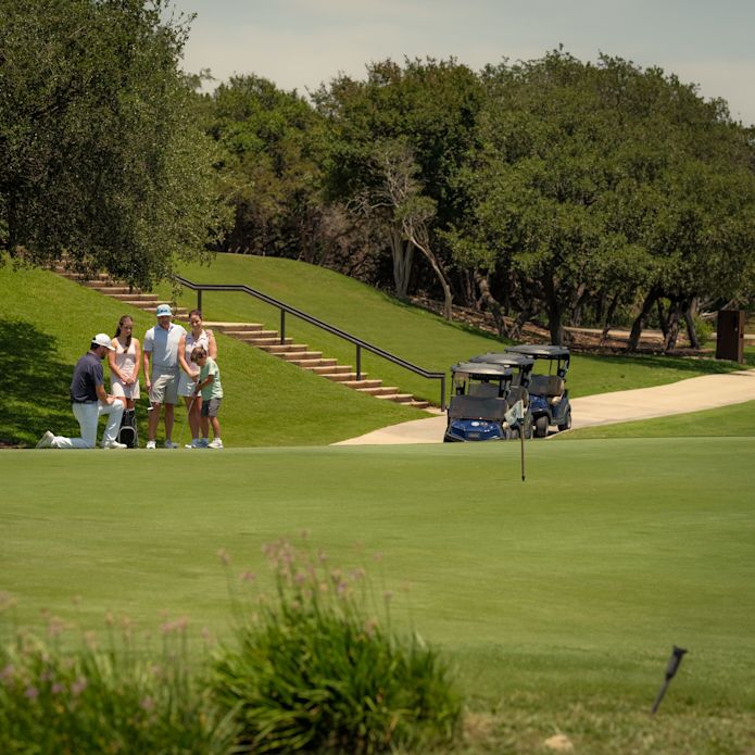 Family playing golf