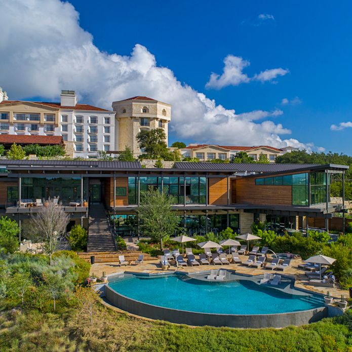Hotel exterior, spa and swimming pool surrounded by trees