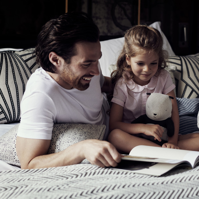 Father with Children on bed reading