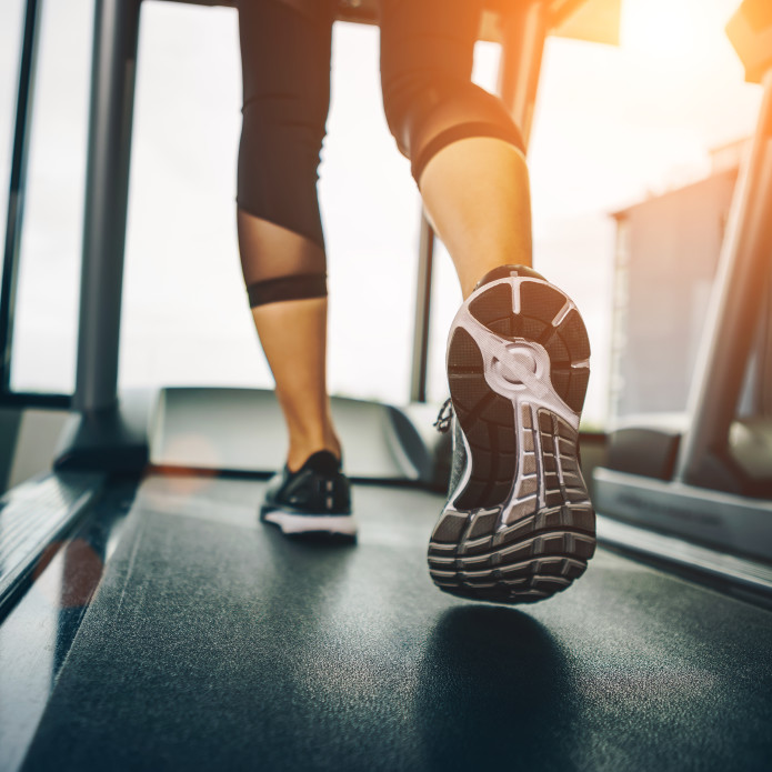 Closeup of woman's legs on a treadmill