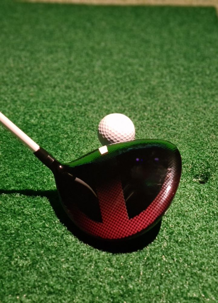 golf club and golf ball on the green