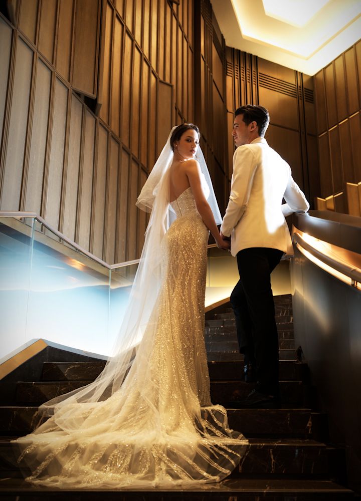 Couple Standing on Lobby Stairs on Their Wedding Day