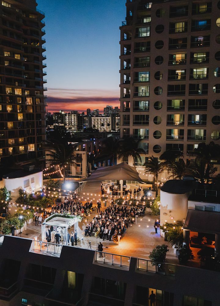 Aerial View of People Attending a Wedding on a Rooftop Terrace
