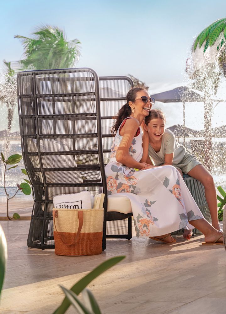 Family with drinks sits near waterpark