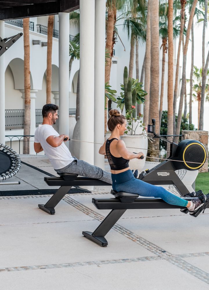 Couple on Outdoor Rowing Machines