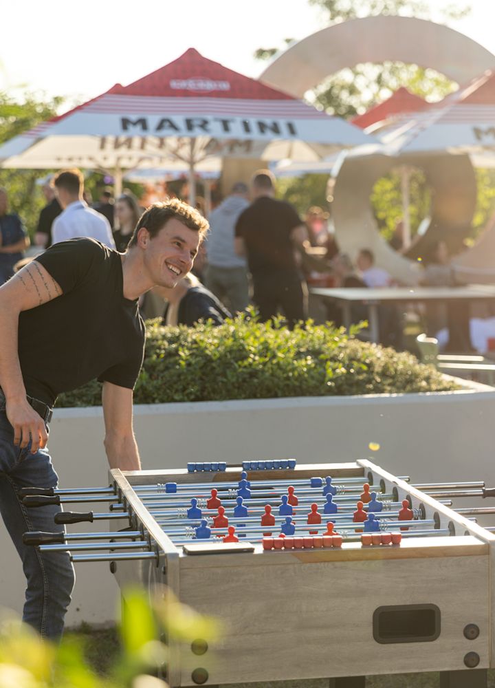 People Playing Foosball at Beer Garden Karlin