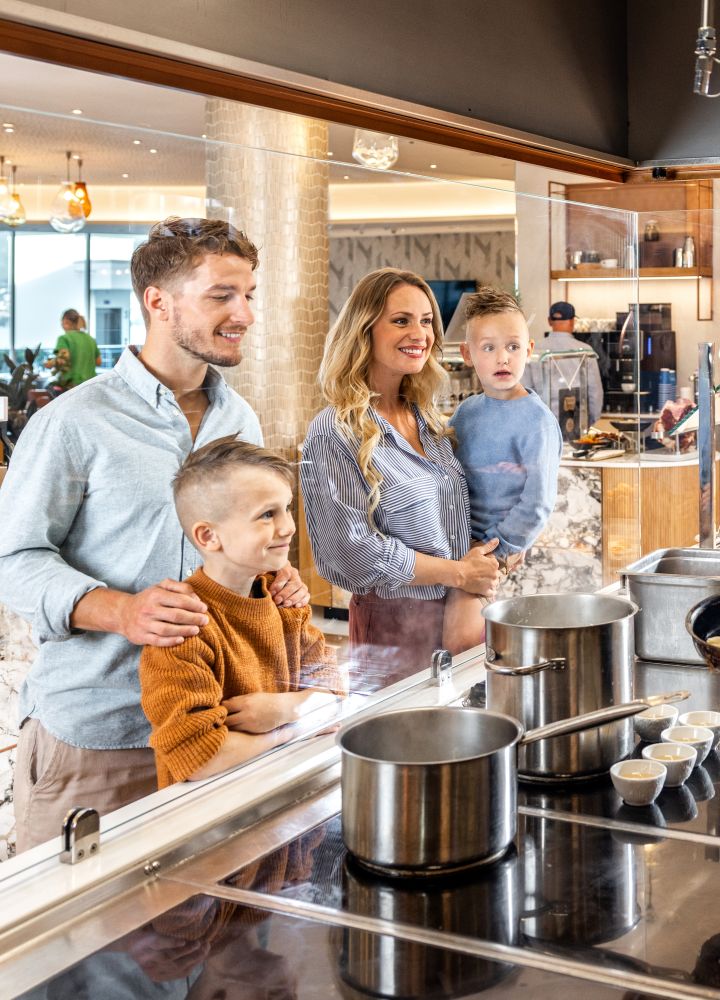 Family watching as chef cooks breakfast