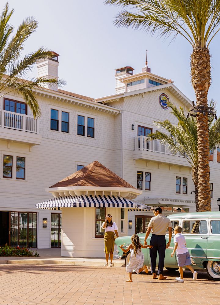 family arriving to hotel outside entrance