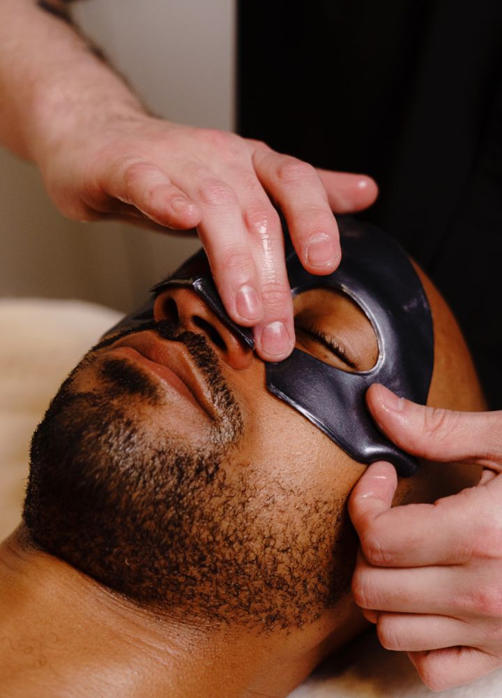 a man getting a facial at the spa