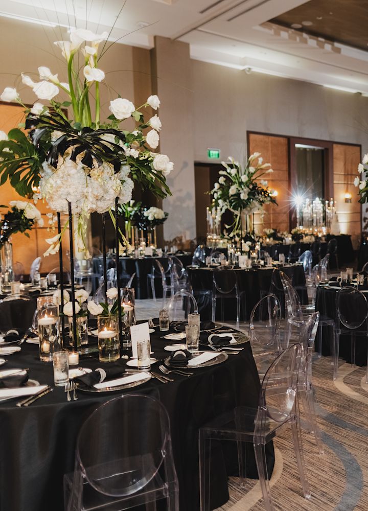Ballroom Setup with Round Tables with Flowers and Candles to Celebrate a Wedding