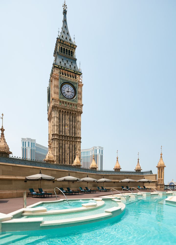 Outdoor Pool Area with Lounge Chairs under Umbrellas
