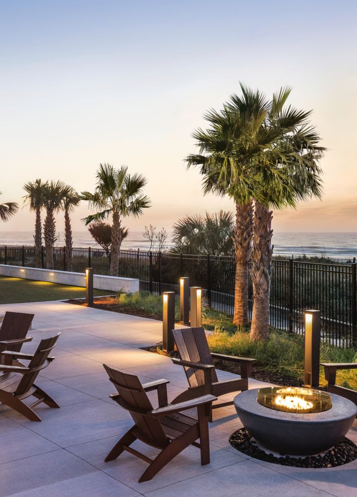 Stunning outdoor fire pit area with ocean view at sunset.