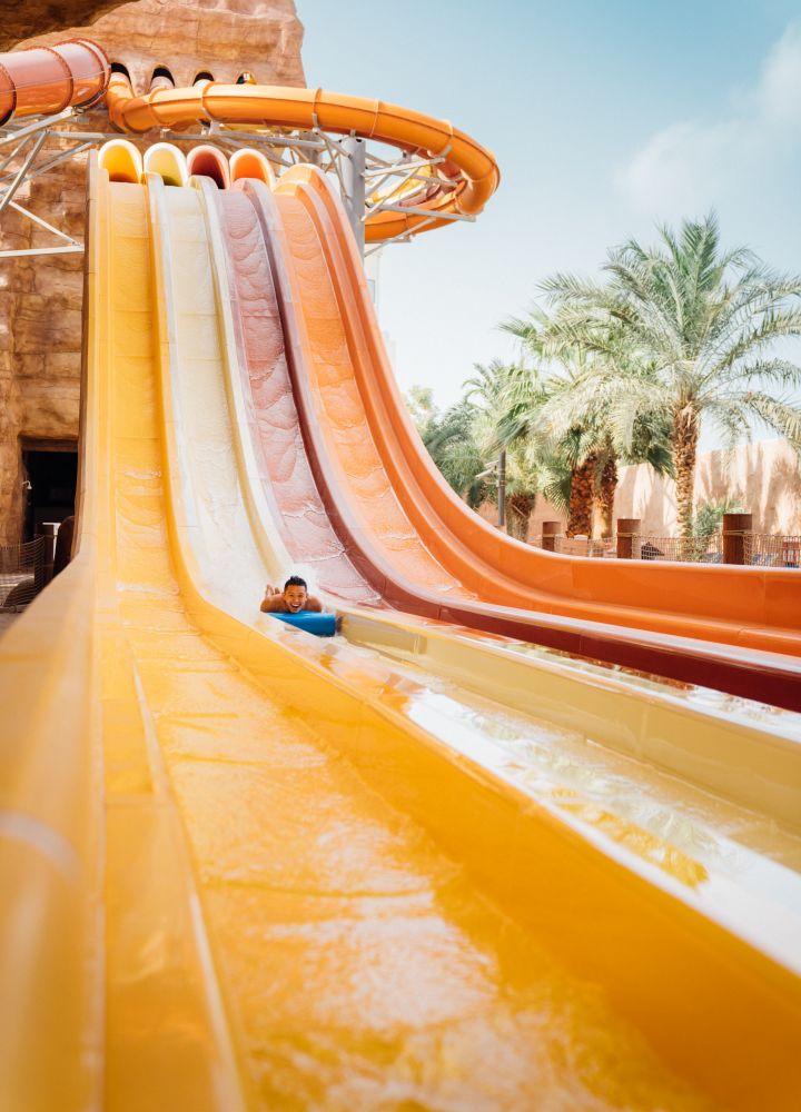 Person sliding down a water slide