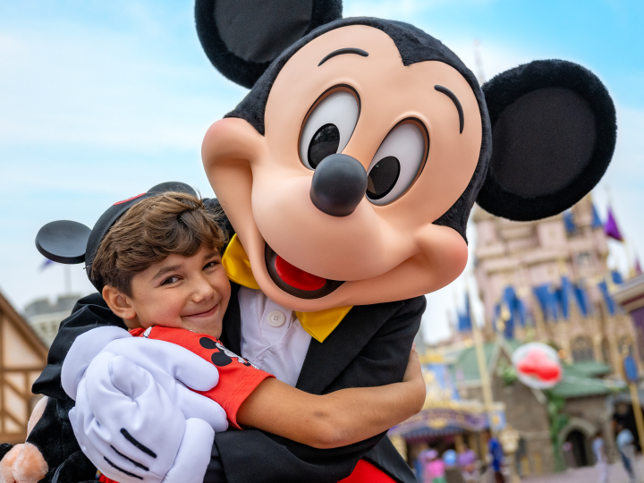 boy hugging mickey mouse