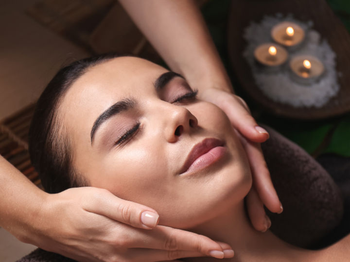 woman receiving spa facial treatment