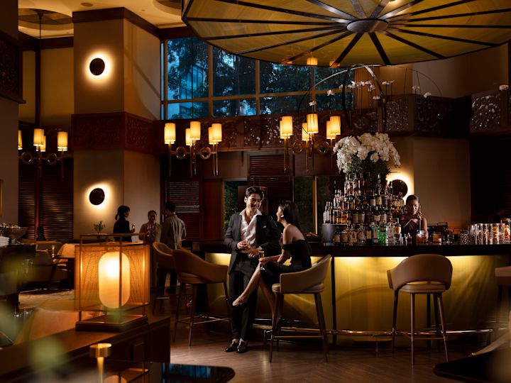 A couple having a drink at the Diplomat Bar.