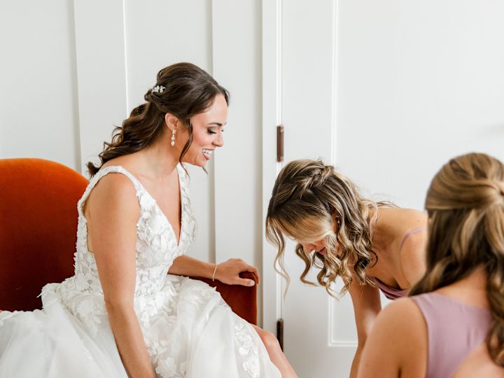 Bridesmaids in a Guest Room Helping the Bride Get Ready for Her Wedding