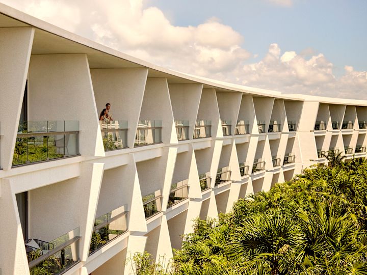 Couple admiring view from hotel room balcony