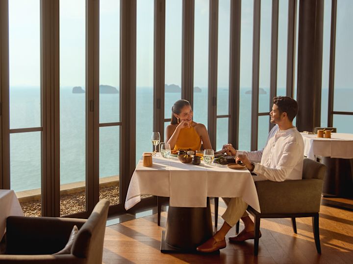 Man and woman sitting at restaurant table with food