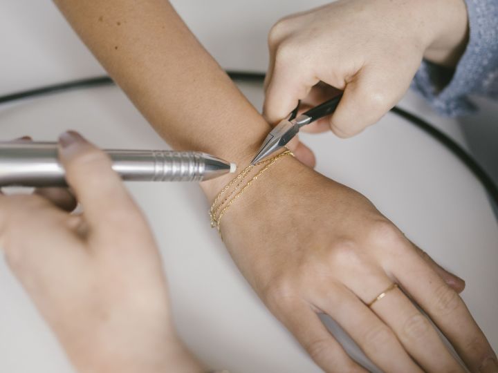 Jewelry bracelet being made on persons wrist