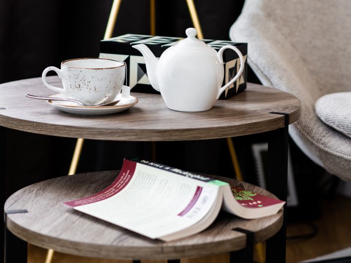 Teapot and teacup on table with book