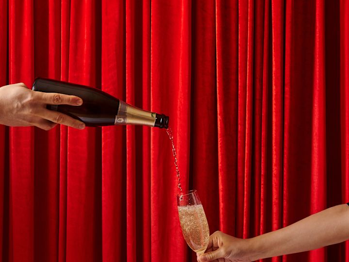 Person Pouring Champagne into a Glass