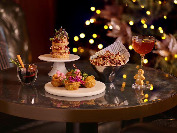 multiple plates of food next with christmas tree in background