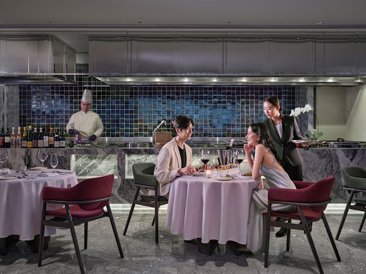 Restaurant area with man and woman sitting down to meal