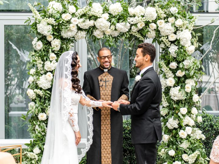 Couple standing at alter with priest
