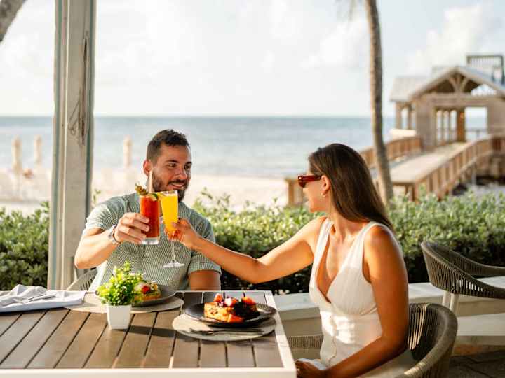 Couple Dining on the Beach at the Four Marlins Restaurant
