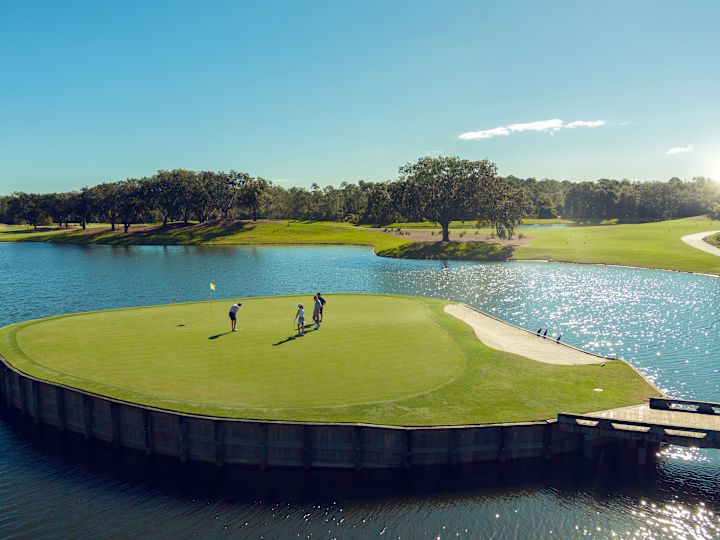 A group of people Golfing on Golf course