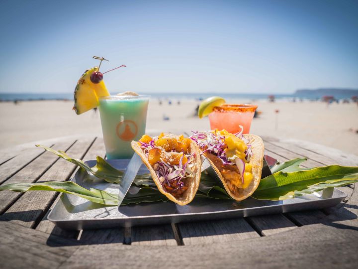 Close-up of tacos with 2 cocktails