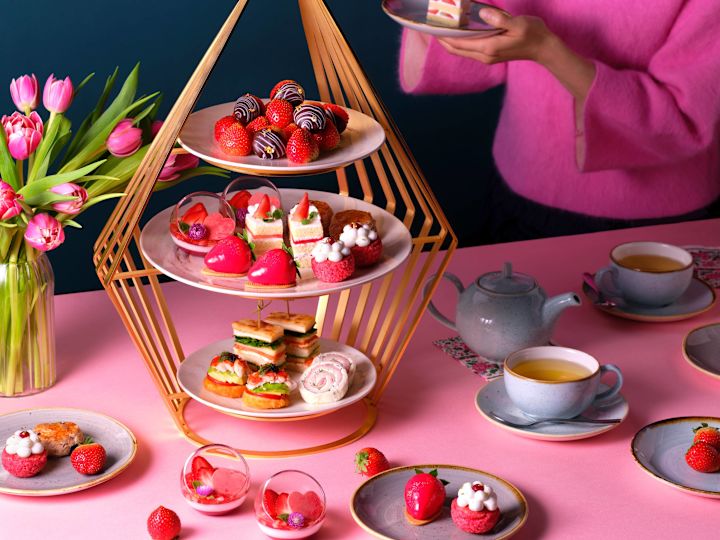 Frau, die ein Stück Kuchen zur Teezeit erhält