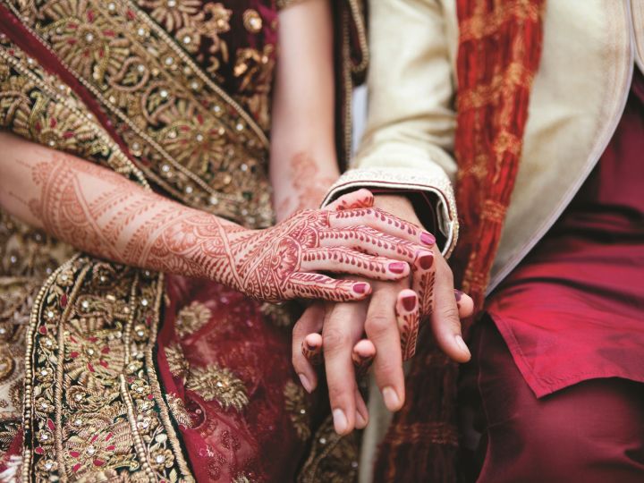 Close Up of Indian Wedding Couple Holding Henna Covered Hands