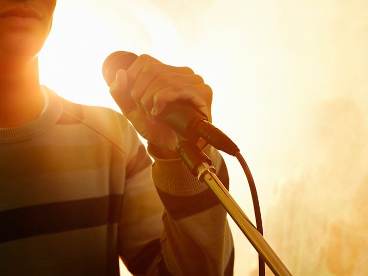 Person singing into microphone