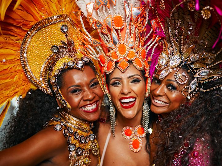 Three Women Hugging to Take a Picture Wearing Colorful Mexican Attire