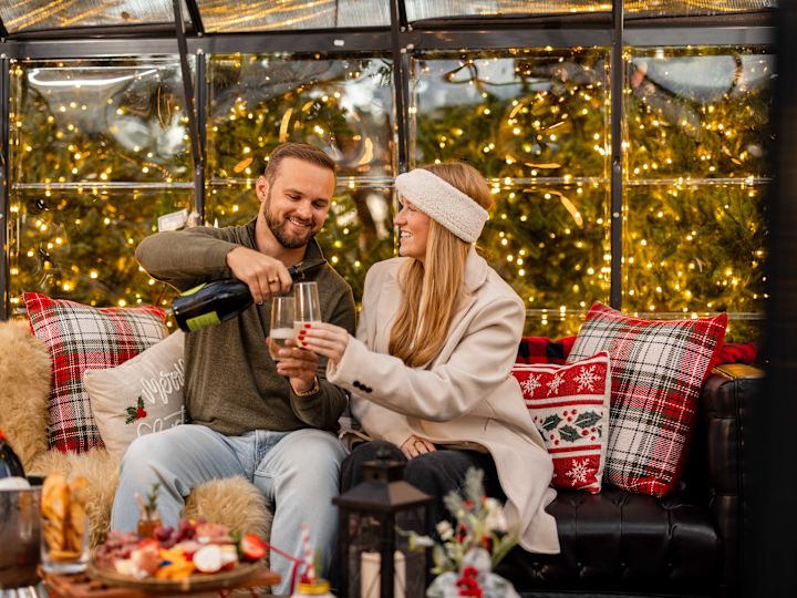 Couple Having Drinks and Snacks in a Cozy Area during the Holidays