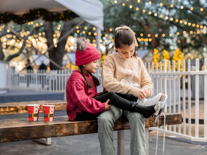 Girls Putting on Ice Skates