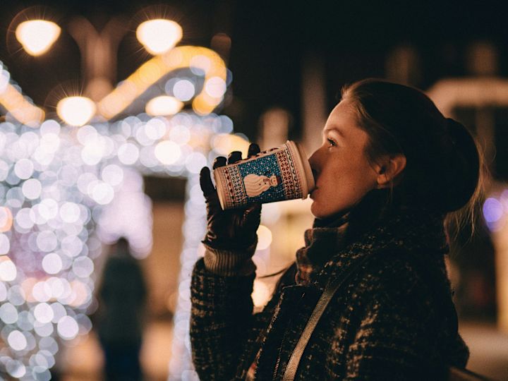 Woman Having a Hot Drink at Christmas Time