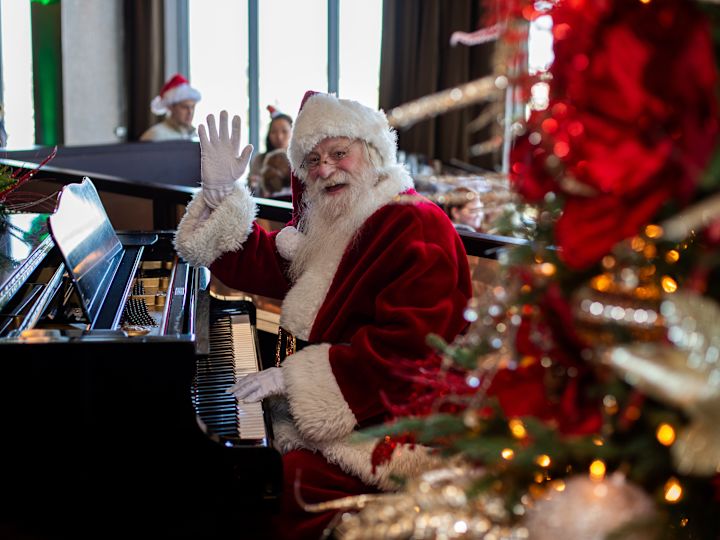 Santa Clauses Playing Piano at a Christmas Celebration