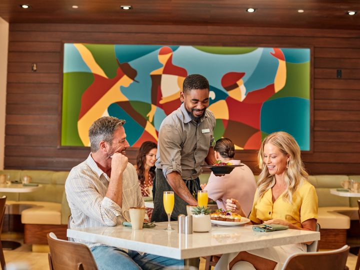 Mezze dining establishment, with 2 guests being served by staff member