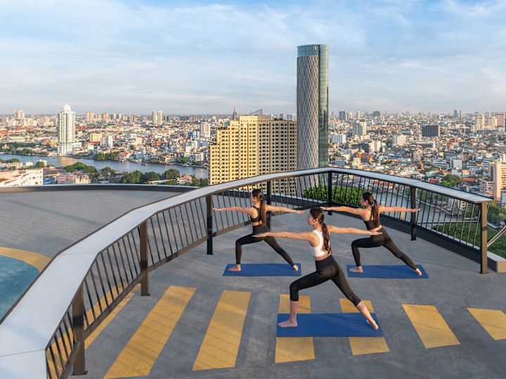 people doing yoga on rooftop