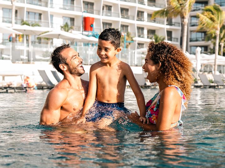 family in outdoor pool